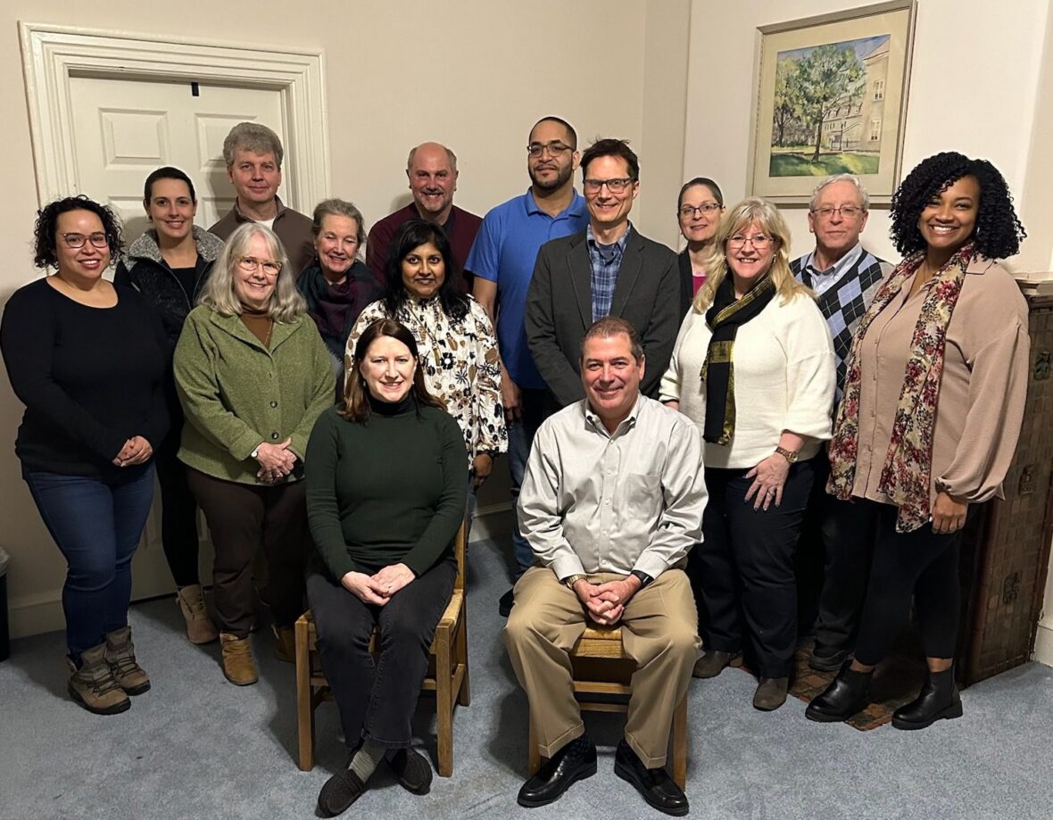 board members stand in a room